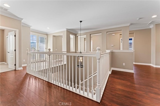 corridor featuring ornamental molding and dark hardwood / wood-style floors