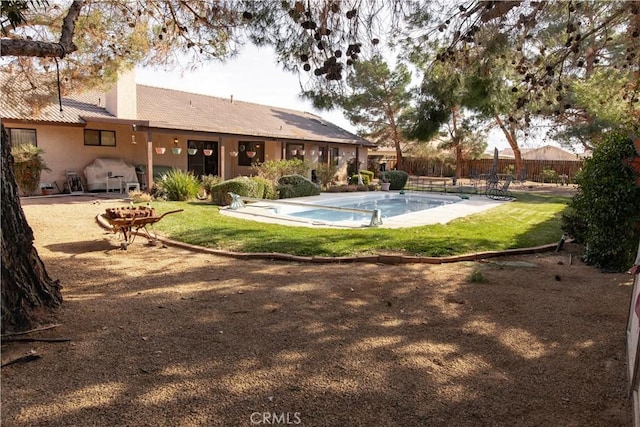 view of pool with a lawn