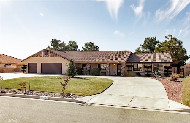 ranch-style house featuring a garage and a front lawn