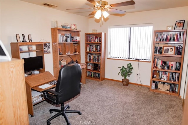 carpeted office space with ceiling fan