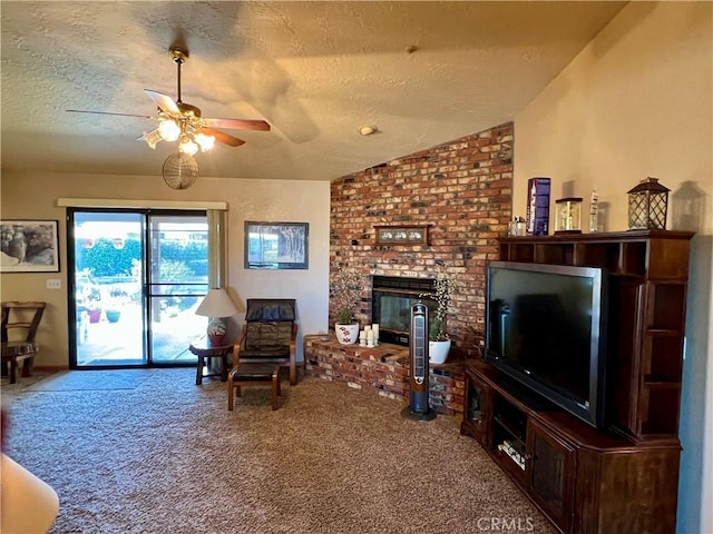 living room with a textured ceiling, carpet, a fireplace, vaulted ceiling, and ceiling fan