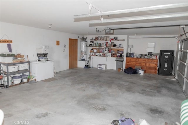 garage with a garage door opener and strapped water heater