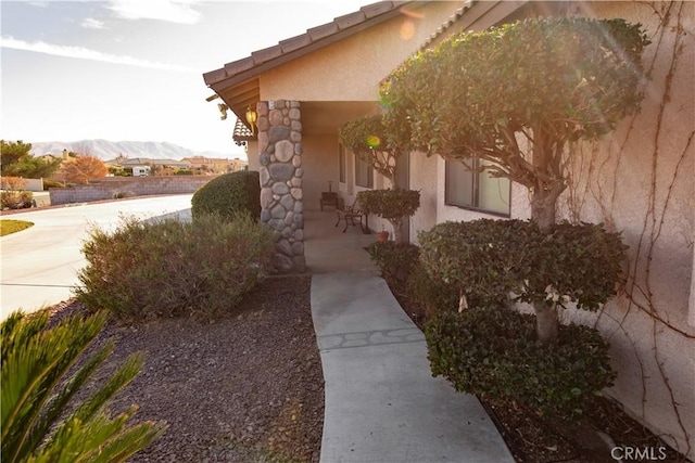 view of property exterior with a mountain view