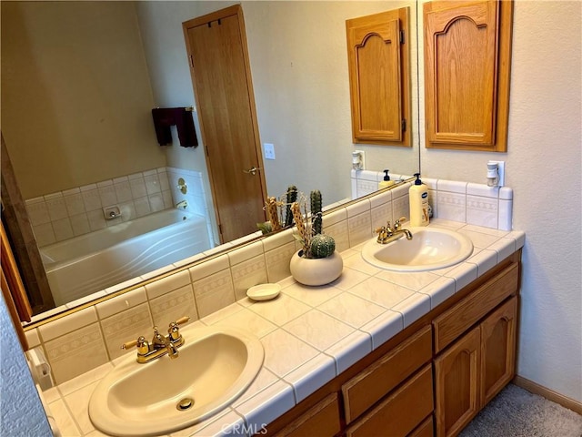 bathroom featuring a tub, backsplash, and vanity