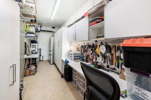 kitchen featuring stainless steel fridge and white cabinets