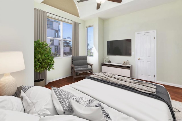 bedroom with ceiling fan, lofted ceiling, and dark hardwood / wood-style flooring