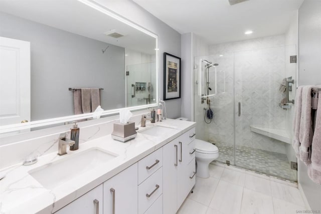 bathroom with tile patterned floors, vanity, toilet, and a shower with shower door