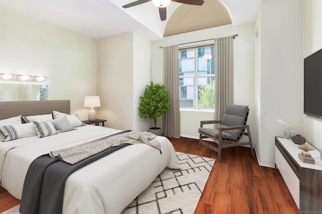 bedroom with vaulted ceiling, dark hardwood / wood-style floors, and ceiling fan