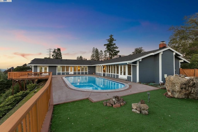 pool at dusk with a yard