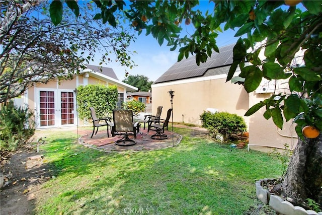 view of yard with a patio and french doors