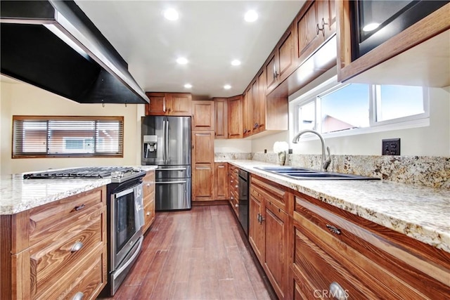 kitchen featuring sink, dark wood-type flooring, appliances with stainless steel finishes, light stone countertops, and exhaust hood