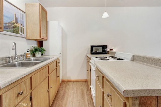 kitchen with white electric range, light brown cabinetry, sink, hanging light fixtures, and light wood-type flooring