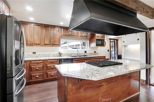 kitchen featuring sink, dark wood-type flooring, a center island, black appliances, and island exhaust hood