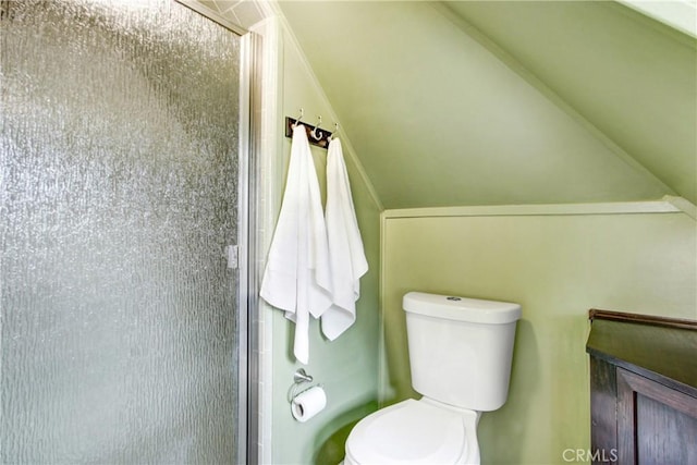 bathroom featuring an enclosed shower and toilet