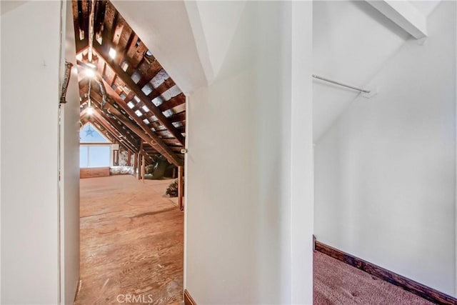 walk in closet featuring lofted ceiling