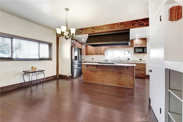 kitchen with stainless steel refrigerator with ice dispenser, a breakfast bar, decorative light fixtures, black microwave, and dark hardwood / wood-style floors