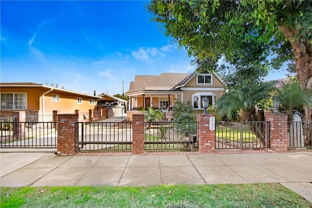 bungalow featuring a fenced front yard and brick siding