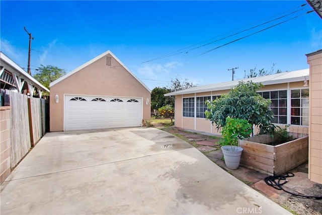 view of front of house with a garage and an outdoor structure