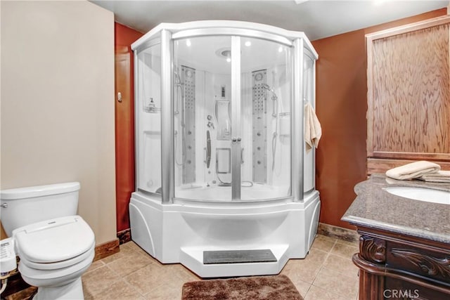 full bathroom with vanity, tile patterned floors, enclosed tub / shower combo, and toilet