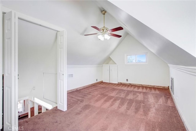 additional living space with ceiling fan, visible vents, baseboards, vaulted ceiling, and carpet