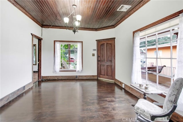 foyer entrance featuring a notable chandelier, ornamental molding, dark hardwood / wood-style floors, and wooden ceiling