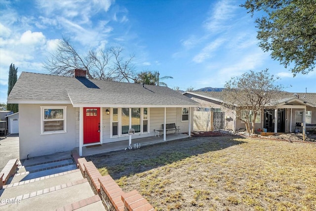 view of front facade with a front yard and a porch