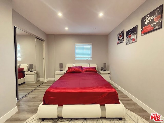 bedroom featuring hardwood / wood-style floors and a closet