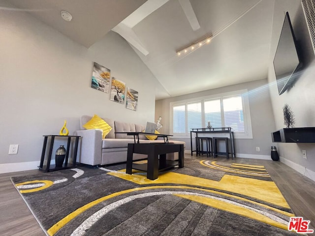 living room featuring wood-type flooring and vaulted ceiling