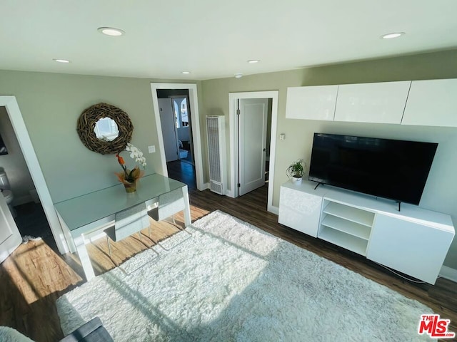 living room with dark hardwood / wood-style flooring