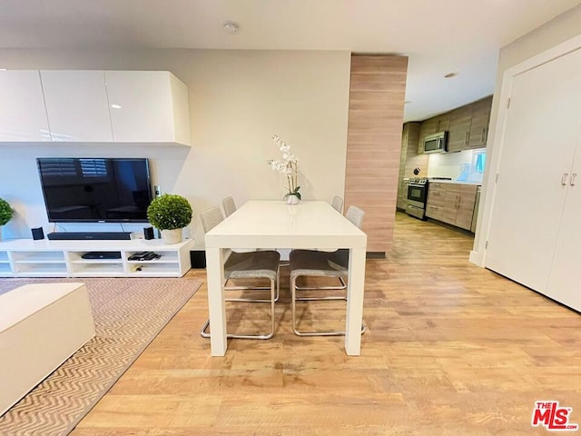 dining space with light wood-type flooring