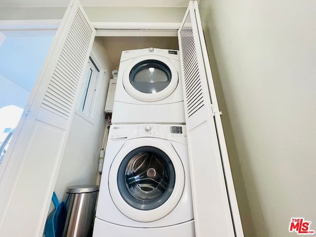 clothes washing area featuring stacked washer / drying machine