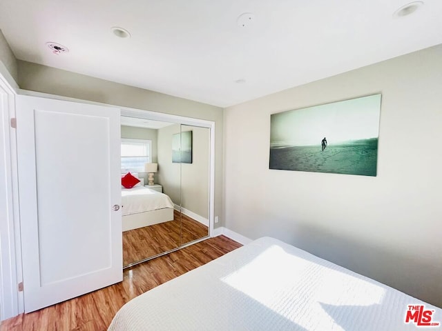 bedroom with hardwood / wood-style flooring and a closet