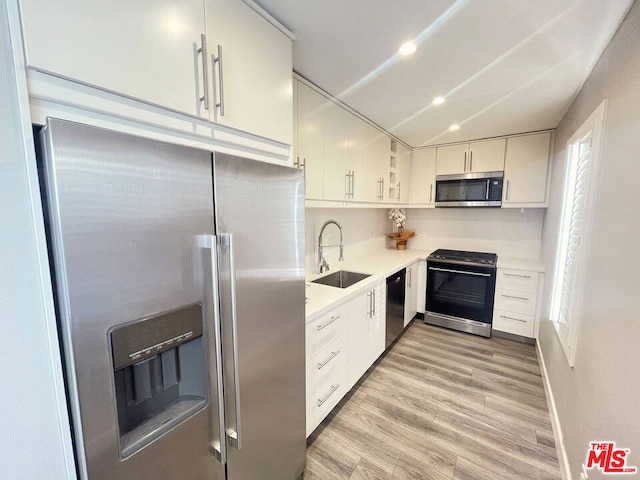 kitchen featuring white cabinets, light wood-type flooring, sink, and stainless steel appliances