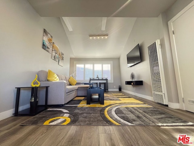 living room with dark wood-type flooring and lofted ceiling