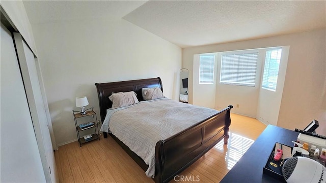 bedroom with light wood-type flooring and a closet