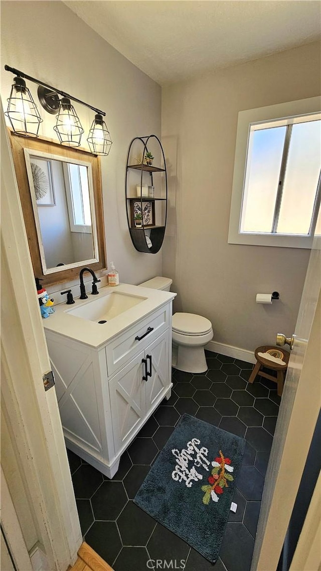 bathroom featuring toilet, tile patterned floors, and vanity