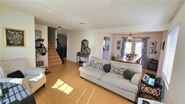 living room with a chandelier and wood-type flooring