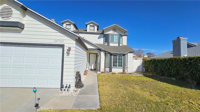 front of property with a garage and a front lawn