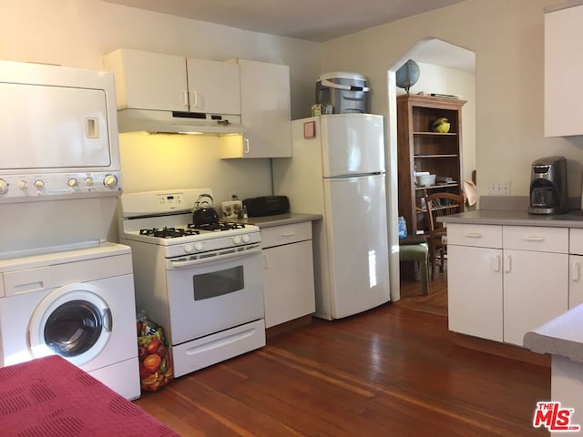 kitchen with stacked washer and dryer, dark wood-type flooring, white cabinetry, and white appliances