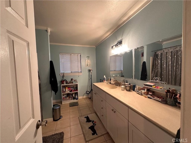 bathroom featuring tile patterned flooring, ornamental molding, and vanity