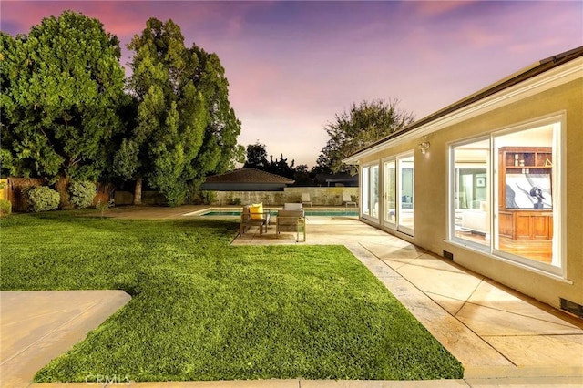 yard at dusk with a patio