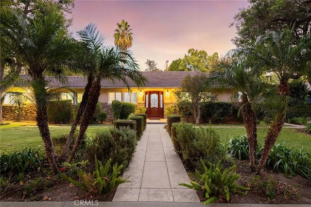 ranch-style house featuring a lawn