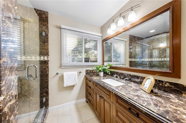 bathroom with walk in shower, vanity, and tile patterned floors