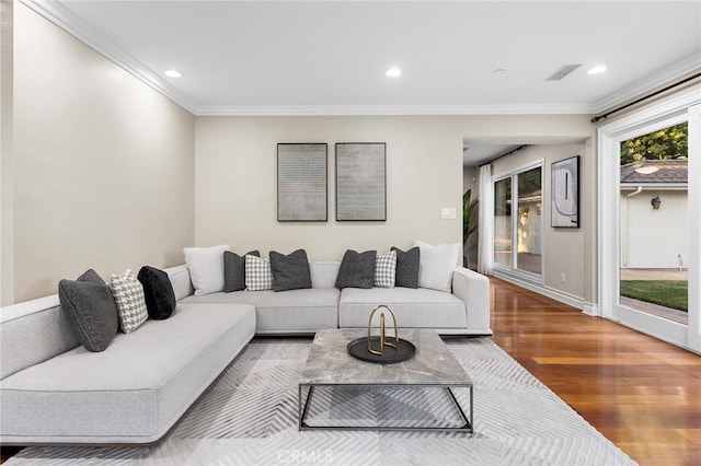 living room with crown molding and hardwood / wood-style flooring