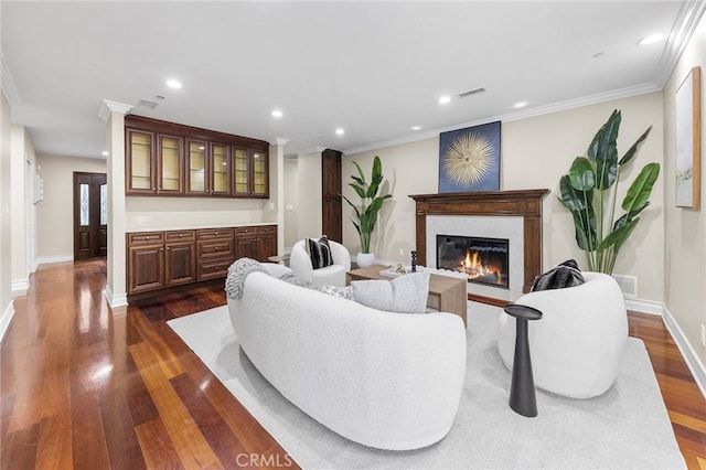 living room with dark hardwood / wood-style floors and ornamental molding