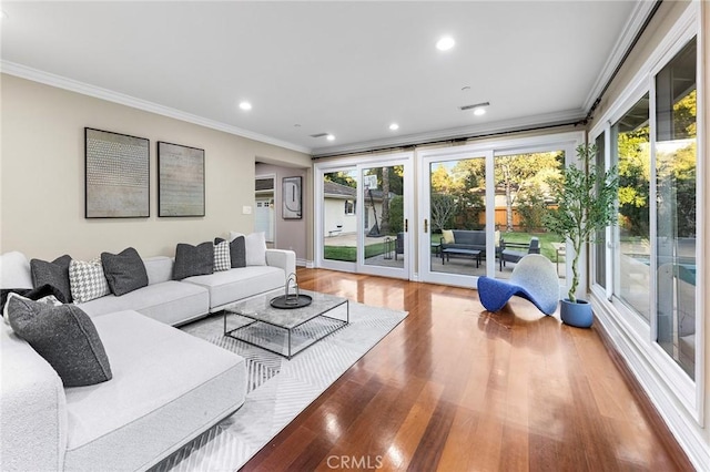 living room with crown molding and wood-type flooring