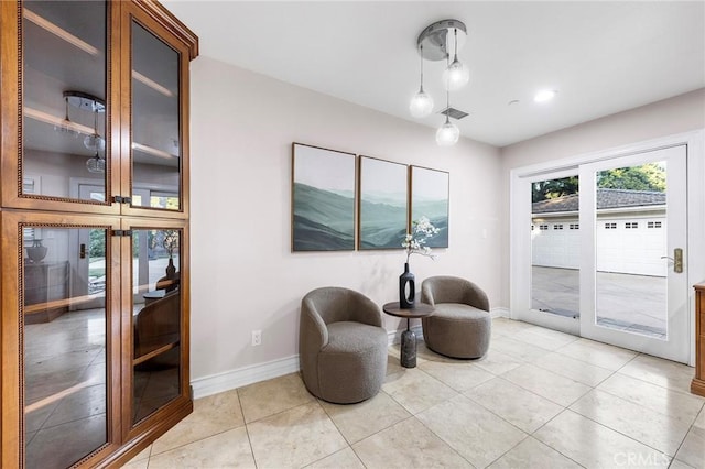 living area with light tile patterned floors and french doors