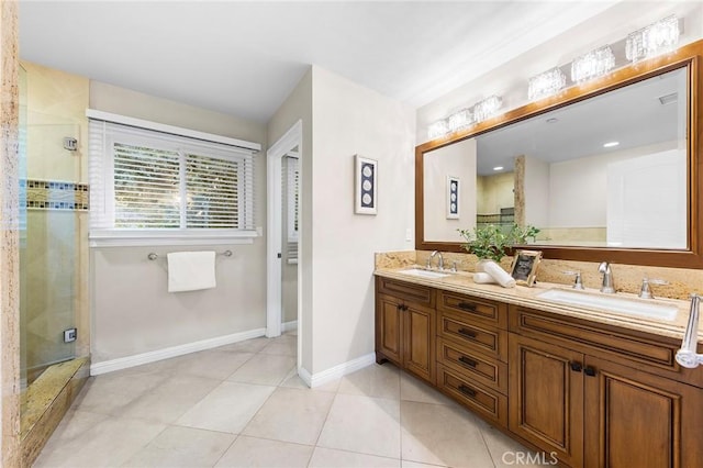 bathroom with tile patterned floors, a shower with door, and vanity