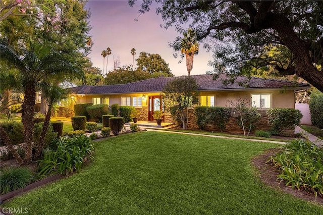 ranch-style house with a yard