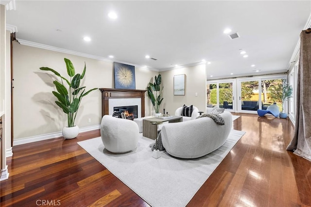 living room with dark hardwood / wood-style flooring and ornamental molding